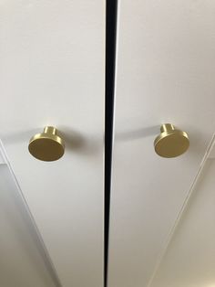 two white doors with brass knobs on them