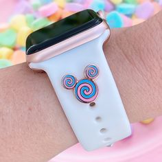 a close up of a person's wrist with an apple watch on it and candy in the background