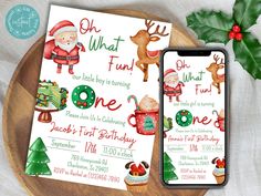 two christmas themed birthday party cards on a wooden plate with holly leaves and an iphone