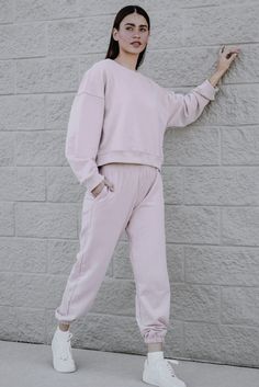 This super comfy essential feels as soft as a cloud and comes in a super flattering hue. Made from a luxe cotton blend, this pink #sweatshirt features classic sweatshirt detailing like the rounded neckline, full-length sleeves, and ribbed trim, while the trendy, boxy silhouette adds a modern update. Complete the look with the coordinating Pink Cloud #joggers and your favorite gold jewelry. 💕 #sweatpants #sweater #loungewear #loungewearset Cloud Sweatshirt, Pink Joggers, Pink Cloud, Trim Fabric, Fashion Themes, Pink Clouds, Pink Sweatshirt, Staying In, Fabric Care