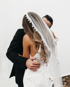 a bride and groom embracing each other in front of a white backdrop with text that reads, i do not know what this image is