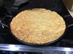 an uncooked pizza sitting on top of a stove