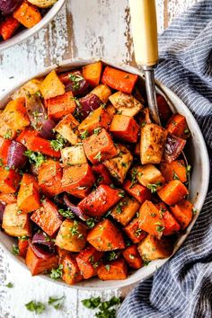 two bowls filled with roasted carrots and potatoes