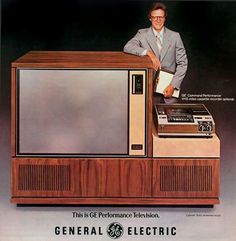 an advertisement for the general electric television, with a man standing in front of it