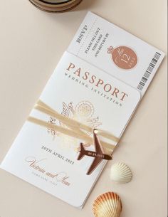 an airplane ticket sitting on top of a table next to seashells