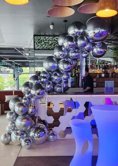 a bar with shiny silver balloons hanging from the ceiling