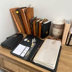 a wooden desk topped with lots of books