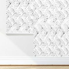 a white wall with black dots on it