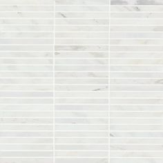 a white marble tile wall with vertical lines in the middle and diagonals on each side