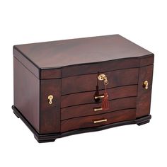 a wooden chest with brass handles and tassels