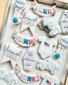 decorated cookies in the shape of usa on a tray