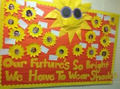 a bulletin board with pictures of people and words written on it that say our futures so bright we have to wear shades