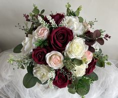 a bridal bouquet with white and red flowers