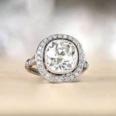 a white diamond ring on top of a wooden table