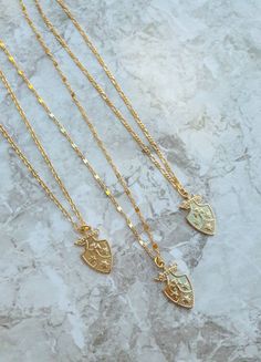 "Medieval Shield symbol charms, Symbol Pendant, Kingdom, empire symbol charms -------------------- DETAILS ・Pendant measures 11.5 x 18mm Chain Options: ・16K gold plated 0.8mm cable chain ・16K gold plated 1.6 x 0.7 mm figaro chain ・16K gold plated 4.3 x 1.8 mm lace chain ------------------- SIZE ・This necklace is available in 2 sizes 16-18\" ( 16\" + adjustable 2\" extender) 18-20\"( 18\" + adjustable 2\" extender) ・It closes with lobster clasp. ------------------- JEWELRY CARE ・Plated brass item Medieval Style Gold Engraved Necklace, Shield Symbol, Empire Symbol, Medieval Shield, Simple Choker Necklace, Medieval Shields, Solid Necklace, Gold Necklace For Women, Initial Necklace Silver