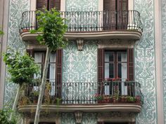 an apartment building with balconies and flowers on the balcony