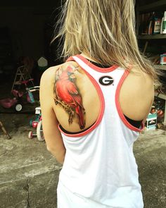 a woman with a red bird tattoo on her back