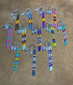 Native American inspired/designed small "stick" earrings are lovingly handcrafted. They are hand beaded, one bead at a time, with glass seed beads.  They come in several color combinations.  Thy are 2" with ear wires. Add a touch of elegance and style to your look with our Single Stick Earrings. With their sleek design and versatile style, these earrings are perfect for any occasion. Plus, they are lightweight and comfortable, so you can wear them all day without any discomfort. Upgrade your jewelry collection and make a statement with our Single Stick Earrings - order yours today! Several color combinations available, if you do not see what you are looking for I can make exactly what you are needing or wanting. If you do not see a color combination that you want/need, let me know as I al Beaded Cone Earrings, Native Bead Earrings, Beaded Ideas, Native Beading, Native Beading Patterns, Stick Earrings, Beaded Earrings Diy, Earrings Diy, Beading Ideas