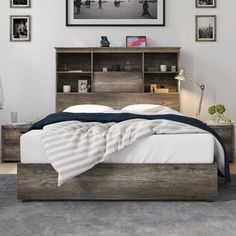 a bedroom with a bed, night stand and pictures on the wall above it's headboard