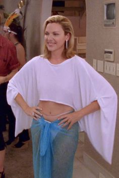 a woman in a white top and blue skirt