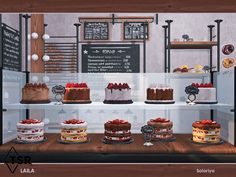 a display case filled with cakes and pastries on wooden counter top next to chalkboard