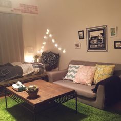 a living room with two couches, a coffee table and pictures on the wall