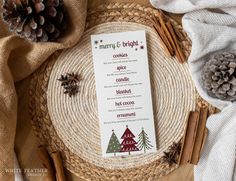 a menu card sitting on top of a place mat next to pine cones and cinnamon sticks