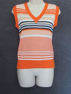 Totally groovy 70's vintage orange white navy and beige striped acrylic knit v neck ribbed trim sweater vest in a size S/M! Great vintage condition! Please see close up pictures for texture, accuracy, color and detail. Tag is a bit worn on the sides, can't make out the name. Only "Subsidiary of Trissi Inc." All acrylic, made in Korea. RN 13142. Super soft knit. Really cute comfy piece! Perfect for anytime! Please feel free to ask any questions and read my return policy before bidding. Additional Acrylic Sweater, Cute Comfy, Vintage Orange, Cute Fits, Orange White, Sweater Vest, Soft Knits, Return Policy, Close Up