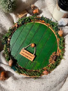 a green plaque with a name on it sitting on a blanket next to other items