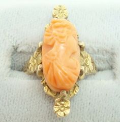 All of our jewelry is guaranteed authentic by our Graduate Gemologist of the Gemological Institute of America (GIA). Art Nouveau 10K Yellow Gold Genuine Natural Coral Cameo Ring Floral (#J2227) 10k yellow gold Art Nouveau ring with an oval coral cameo and beautiful cast mounting with flowers. The cameo measures 15mm x 8mm. The ring fits a size 4 3/4 finger and dates from 1895-1905. It weighs 2.9 dwt. Amazing! Inventory#RF2396. SKU#J2227. 100% Satisfaction Guaranteed! Oval Yellow Gold Cameo Ring, Oval Cameo Yellow Gold Ring, Yellow Gold Carved Oval Ring, Carved Yellow Gold Oval Rings, Carved Oval Yellow Gold Ring, Art Nouveau Ring, Coral Art, Sterling Silver Flatware, Cameo Ring