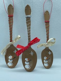 three spoons decorated with snowmen on them