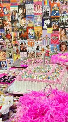 a table topped with lots of cakes covered in frosting and sprinkles