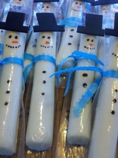 snowmen are wrapped in plastic and tied with blue ribbon