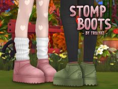 a pair of boots with hearts on them are standing in front of a flower garden