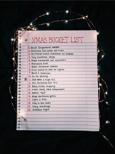 a christmas bucket list with lights around it