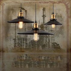 three light fixtures hanging from a ceiling in front of a wall with an industrial background