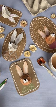 some paper plates with bunnies and flowers on them next to a cup of coffee