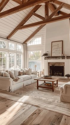 a living room filled with furniture and a fire place in the middle of an open floor plan