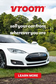 a white car parked on top of a lush green field next to a red sign that says, vroom sell your car from wherever you are learn more