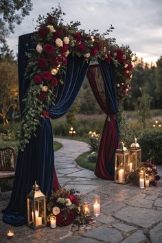 an outdoor ceremony with candles and flowers