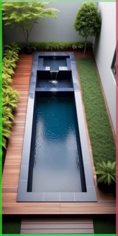 a small pool in the middle of a wooden deck with grass and trees around it