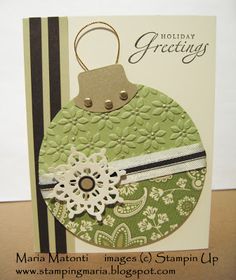 a green christmas ornament with white lace on it and a tag hanging from the front