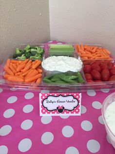 a table topped with lots of veggies and dip