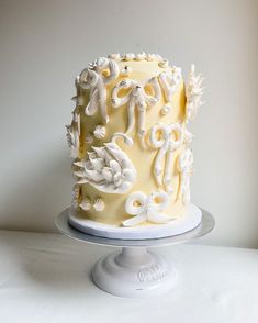 a cake with white frosting and decorative designs