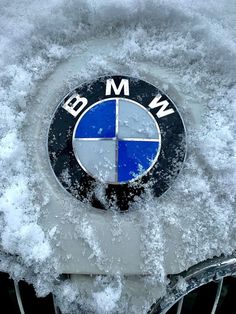 the bmw emblem is covered in snow and ice