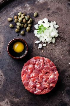 ingredients to make an appetizer laid out on a stone platter