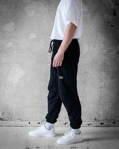 Upgrade your casual wardrobe with the Bregos Men's Black Pants. These versatile pants are perfect for any occasion, offering a blend of comfort and style. Made from 100% premium cotton, they are ultra-soft and breathable, ensuring all-day ease. The elastic waistband with an adjustable drawstring provides a secure and customizable fit. Features include side pockets and a back pocket for convenience, and ribbed cuffs for a modern look. Pre-shrunk so no surprises in the wash, and available in vario No Surprises, Black Pants Men, Versatile Pants, Comfortable Pants, Men's Sweatpants, Mens Sweatpants, Pants Black, Stylish Men, Casual Wardrobe