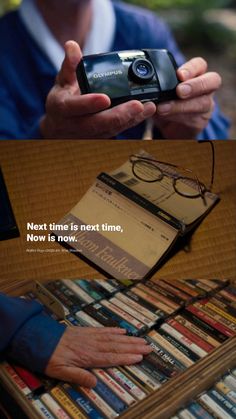 a person holding a cell phone in front of a book shelf with books on it