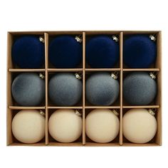 an open box filled with blue and white balls on top of each other in front of a white background