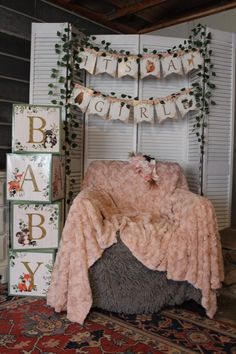 a baby's room decorated with pink and green decorations, including a teddy bear on the bed